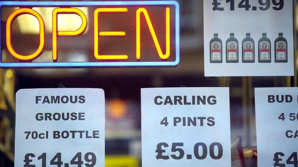 A shop sign with drink prices in the window