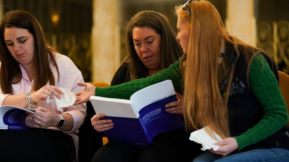 (L to R) Steph Hotchkiss, Carley McKee and Chelsey Campbell read pages of the Ockenden report