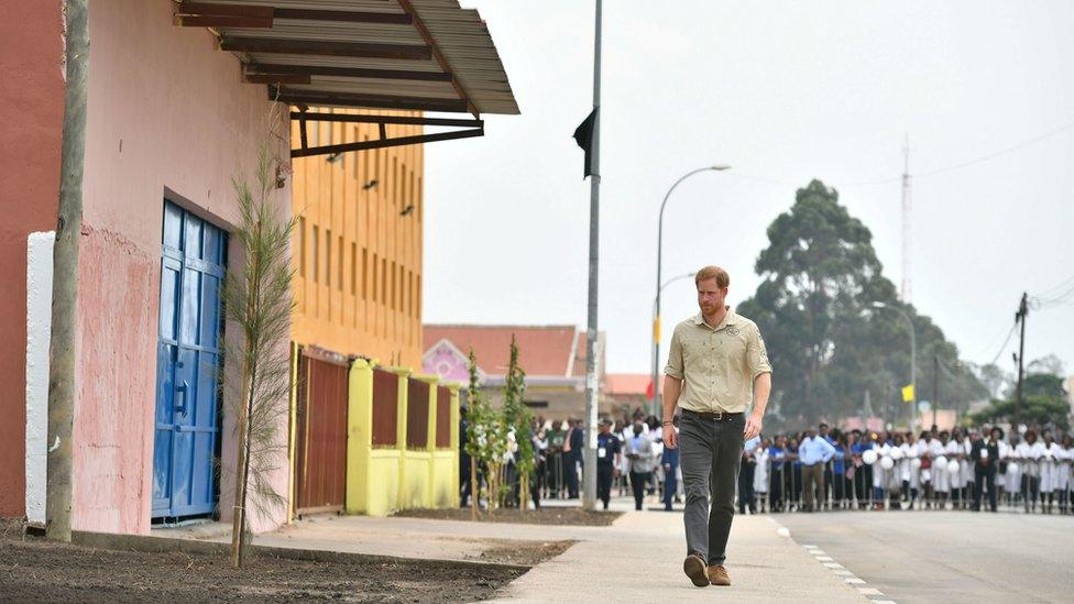 Prince Harry, Duke of Sussex, walks on Princess Diana Street on day five of the royal tour of Africa, in Huambo