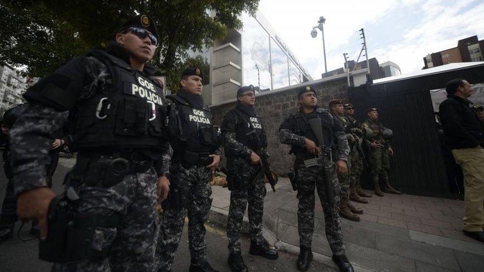 Security forces stand guard outside the National Electoral Council building in Quito on February 20, 2017, where supporters of Ecuadorean presidential candidate for the CREO party Guillermo Lasso, protest as they wait for the final results of Sunday"s presidential election.