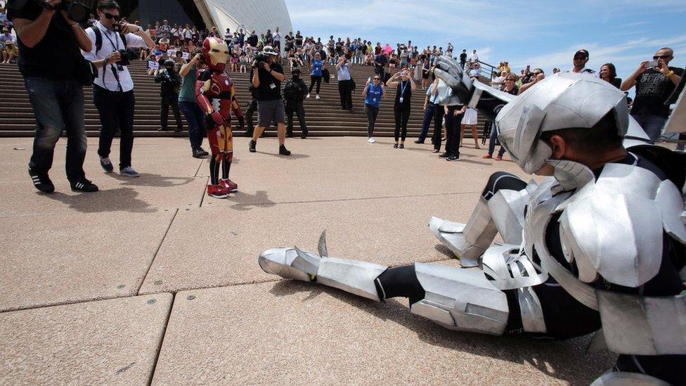 Iron Boy stands before the vanquished Ultron in front of the Sydney Opera House