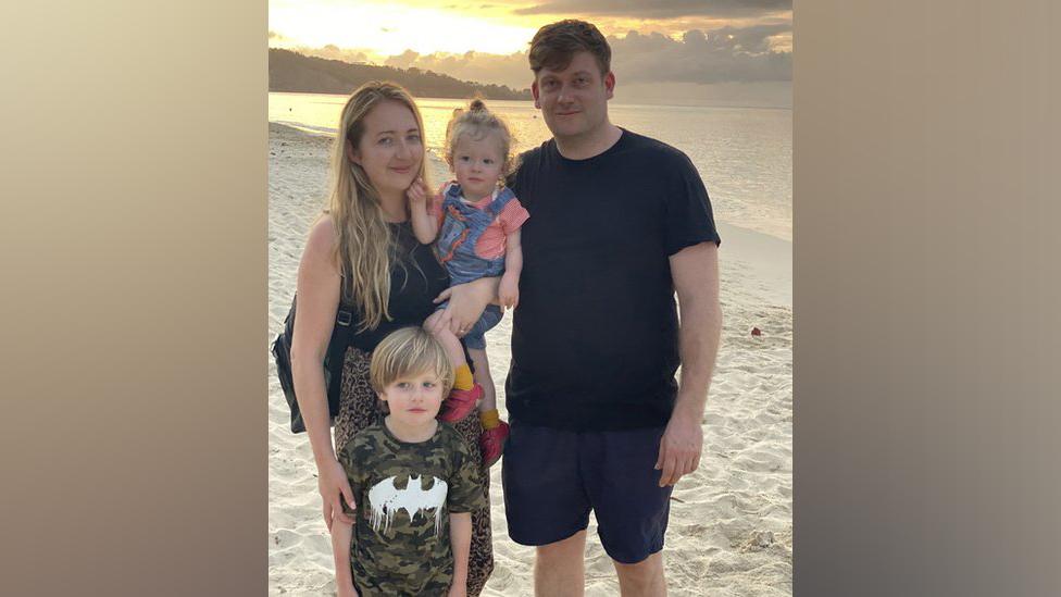 Ceri and Frances Menai-Davis with their two children on a beach