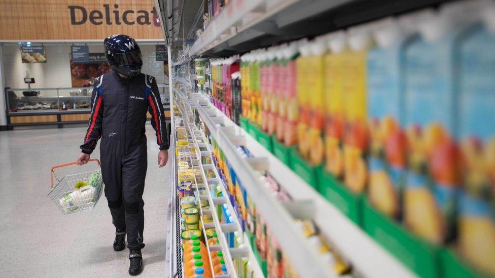 Racing driver doing shopping in supermarket