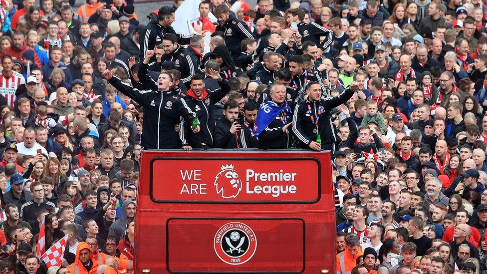 The Sheffield United players and manager Chris Wilder wave to the fans during the promotion parade in Sheffield City Centre