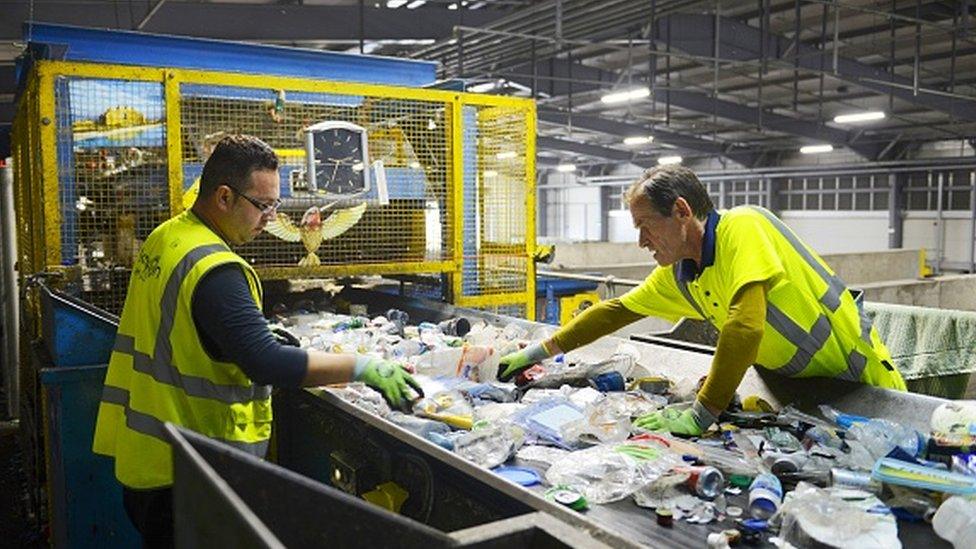 Employees sort waste at the Lampton 360 Recycling Centre