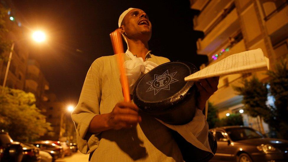 El Mesaharty, Hussien, 40, wakes up residents for their pre-dawn meals during the first day of Ramadan in Cairo, Egypt June 6, 2016