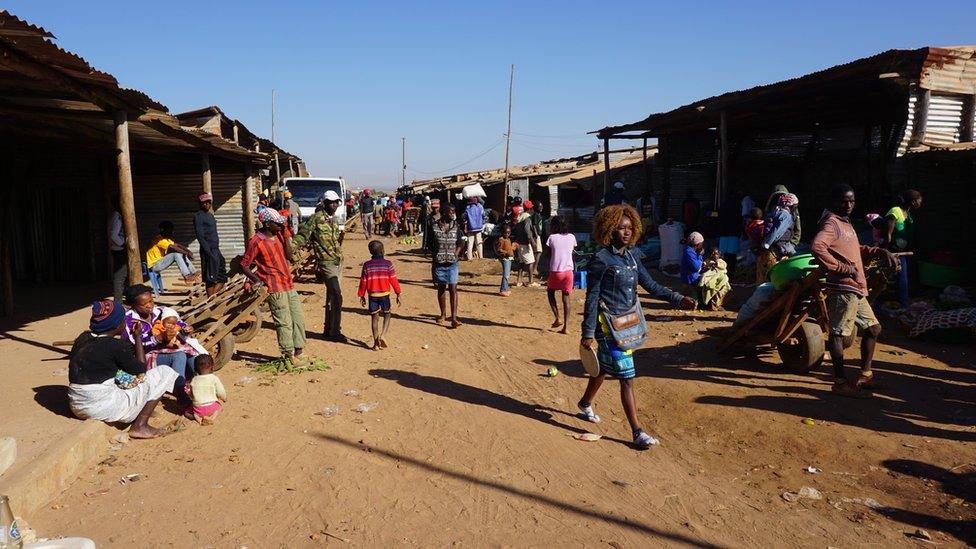 Bushmeat market, people walking, in Angola June 2016
