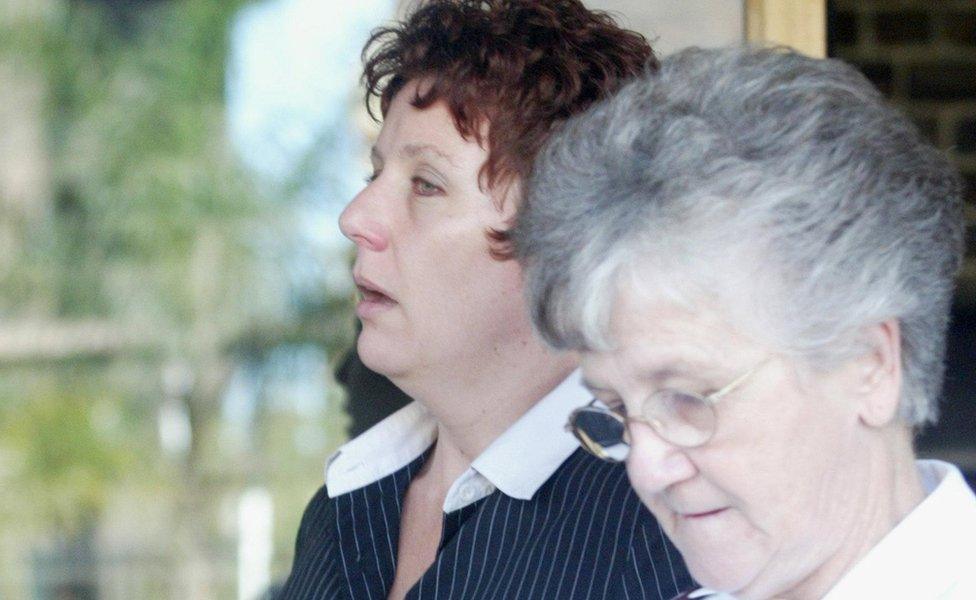 Kathleen Folbigg leaves Darlinghurst Court during her trial during April 2003 with the support of Salvation Army major and support worker Joyce Harmer