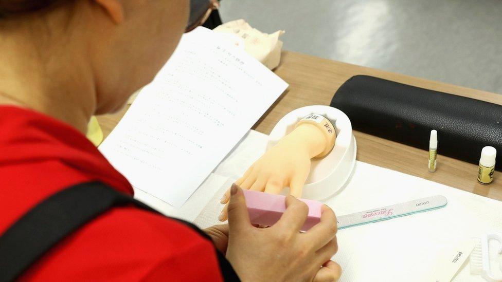 Defector learns how to do a manicure