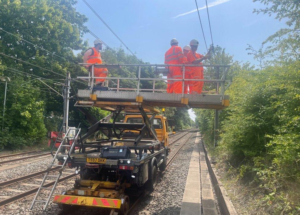 Metro staff work to fix the sagging lines