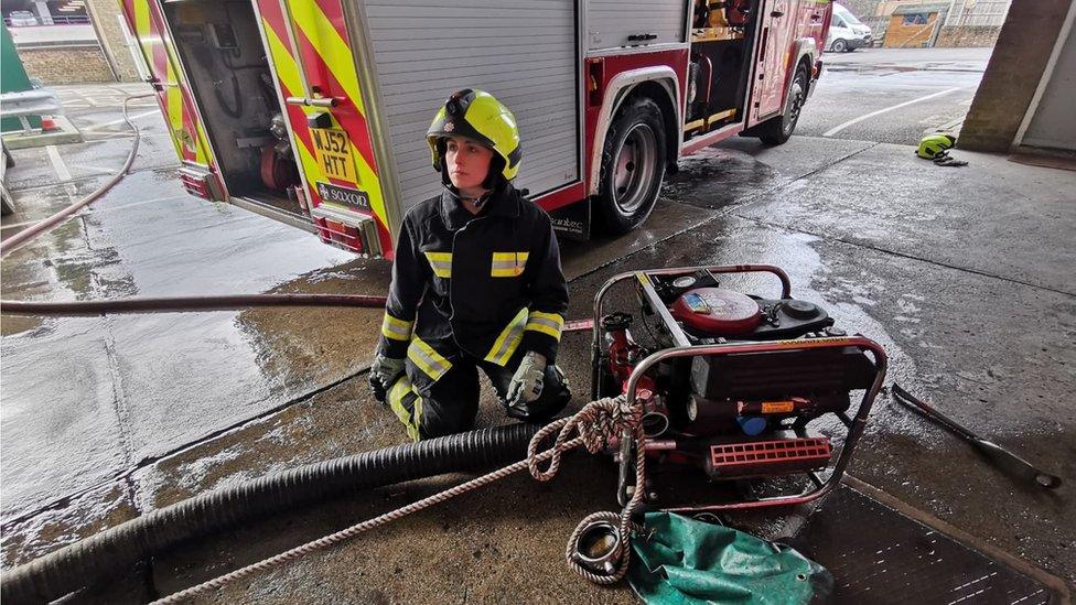 Elsie Emery practicing using firefighting equipment