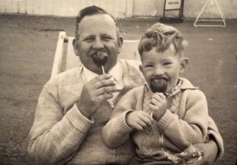 Ian eating a toffee apple with his dad