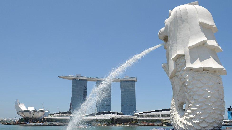 A picture shows the Marina Bay Sands casino and hotels standing in the background, facing the Merlion, in Singapore