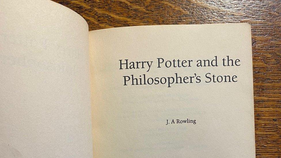 proof copy is open with the title harry potter and the philosopher's stone and a misspelling of jk rowlings name which reads ja rowling