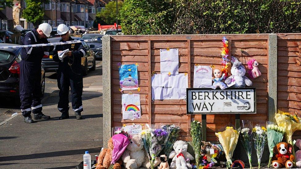 Flowers are laid near to the scene