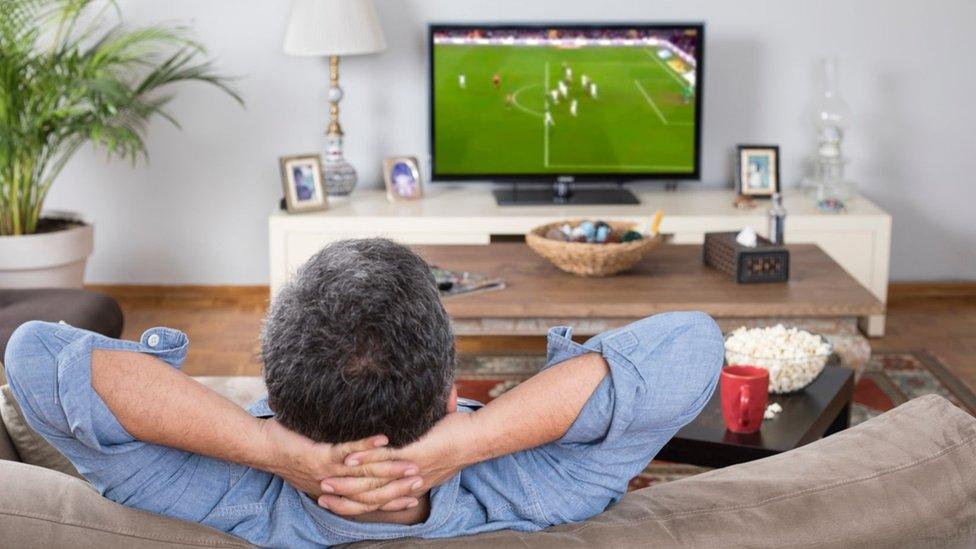 Man watching TV at home