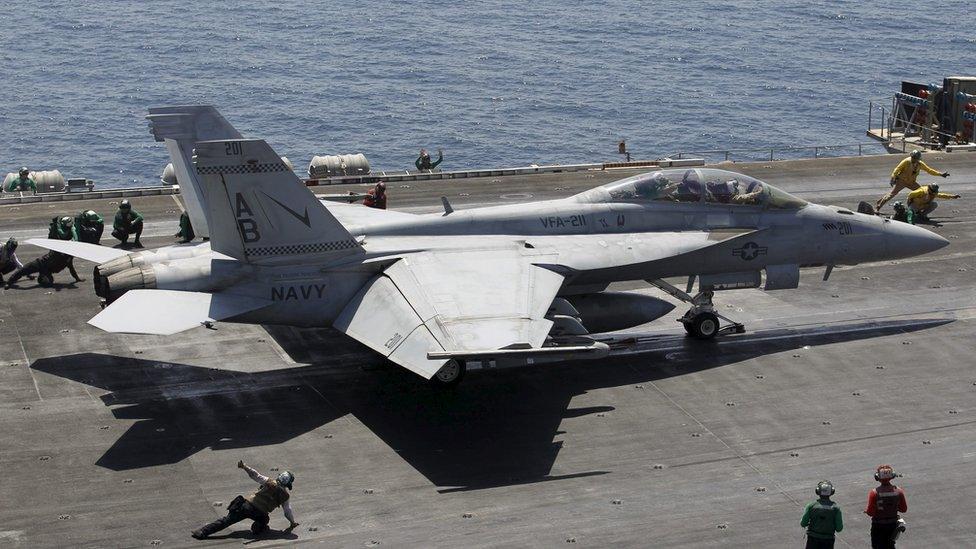 A F/A-18E/F Super Hornets of Strike Fighter Attack Squadron 211 (VFA-211) is lined up for take off on the flight deck of the USS Theodore Roosevelt (CVN-71) aircraft carrier in the Gulf June 18, 2015.