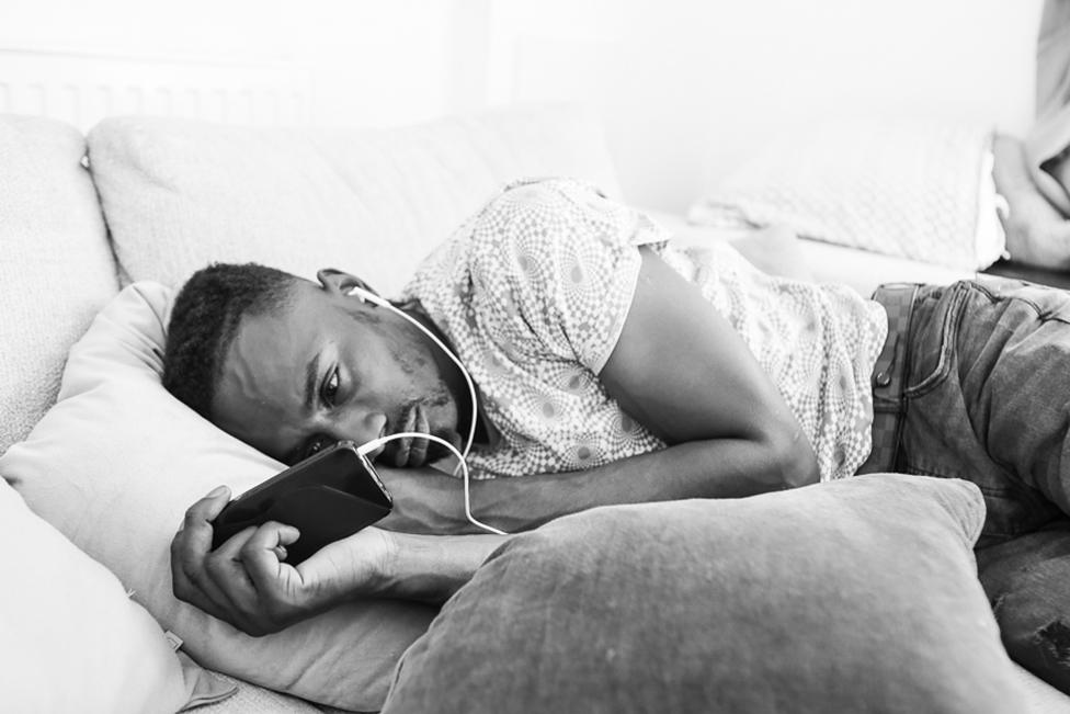 A man looks at a mobile phone