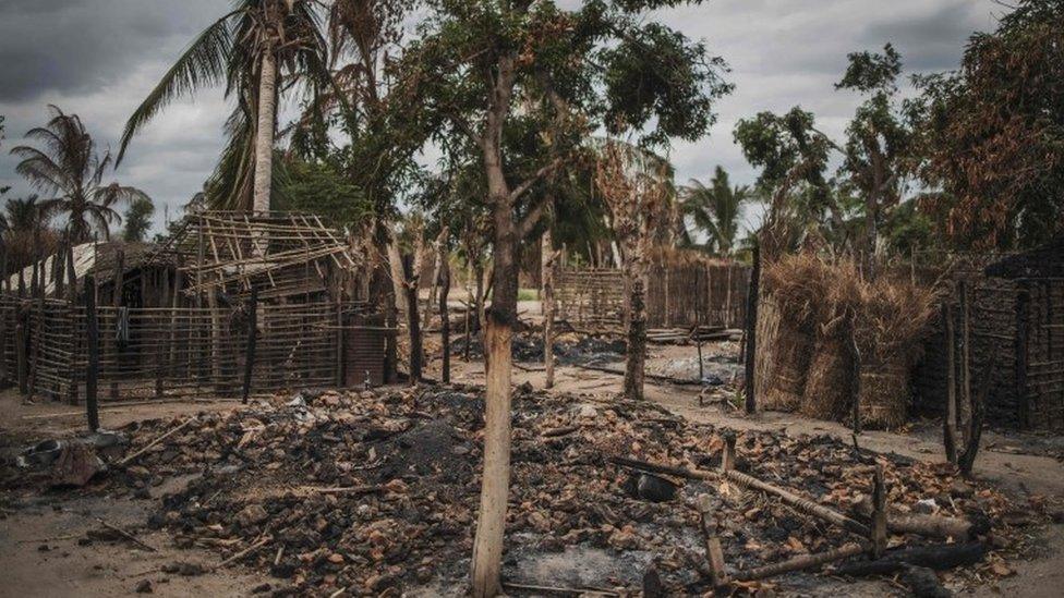 In this file photo taken on August 24, 2019 The remains of a burned and destroyed home is seen in the recently attacked village of Aldeia da Paz outside Macomia