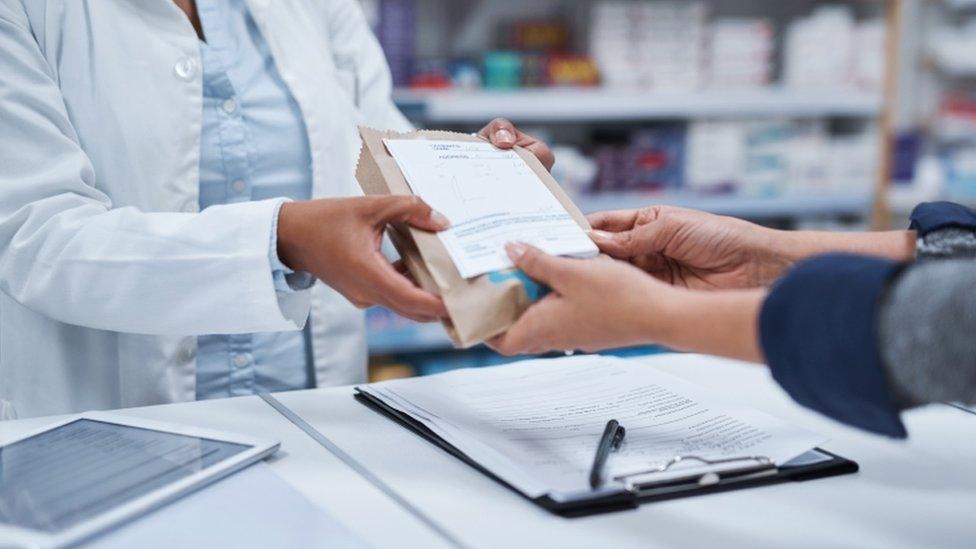 Pharmacist serving a customer