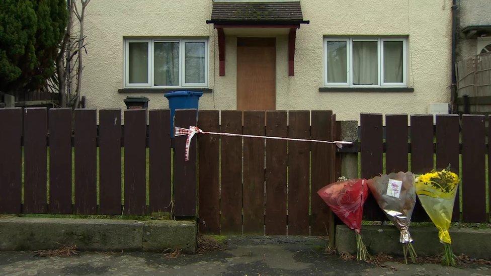 Floral tributes outside the house in which Wayne Boylan was killed