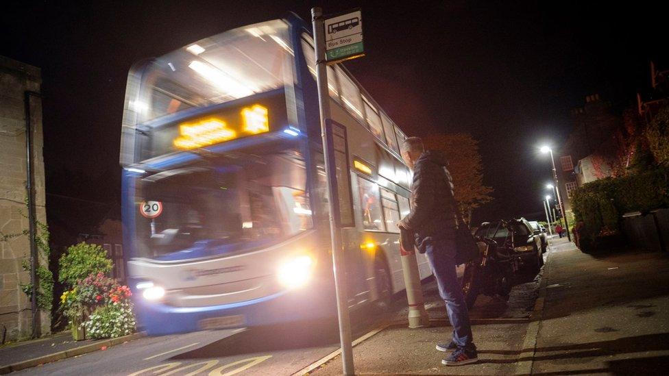 Passenger waiting for the number 16 bus in the early morning