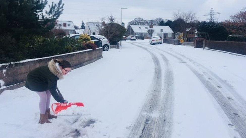 Poppy Banks clearing snow in Aberdeen