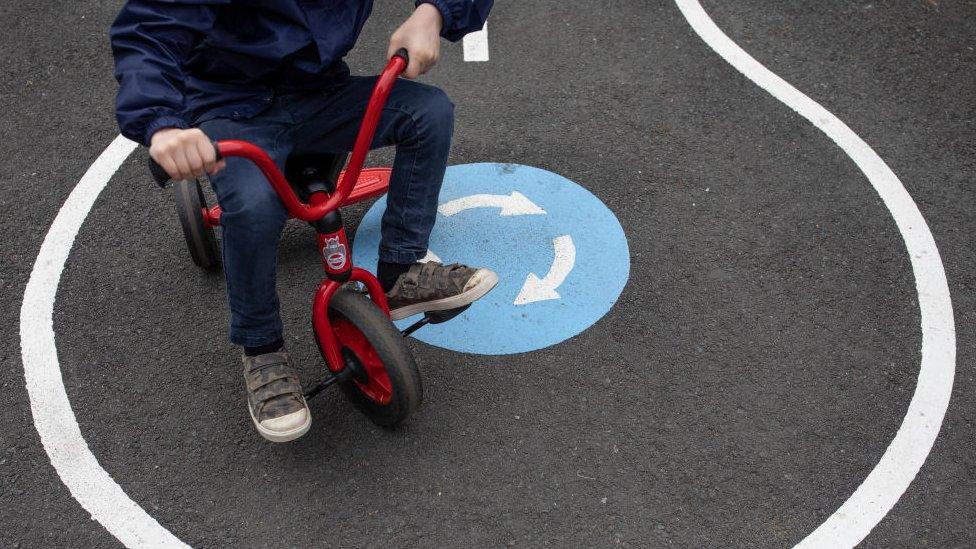 Child riding on a tricycle