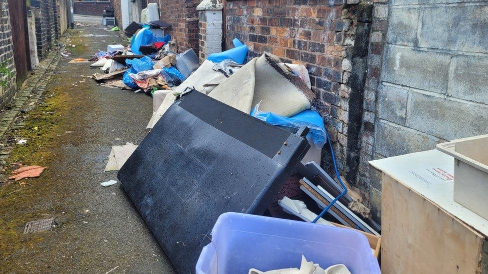 Fly-tipping in the alleyway