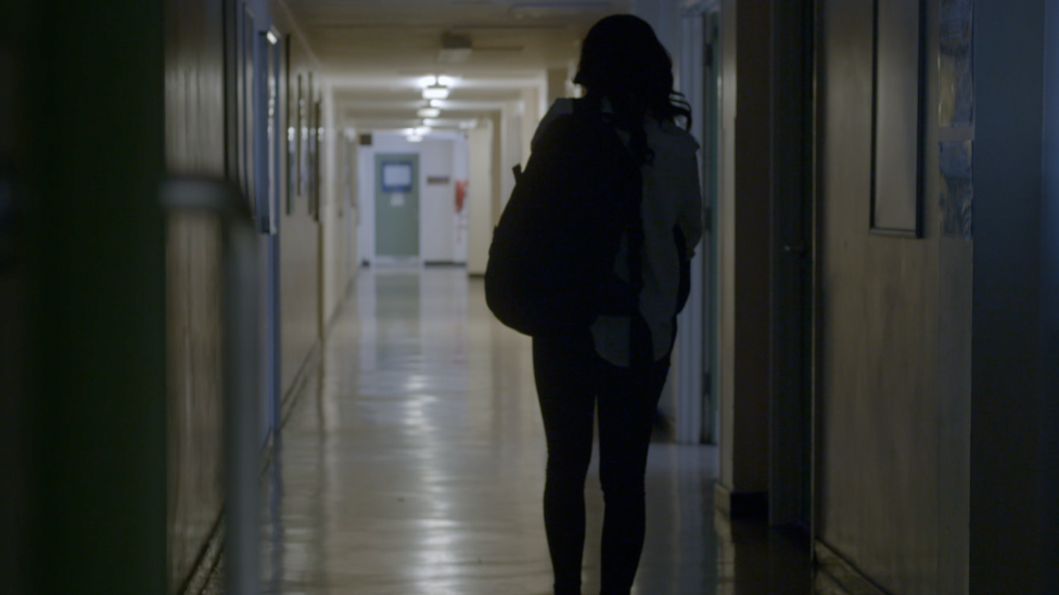 Girl walking in school corridor