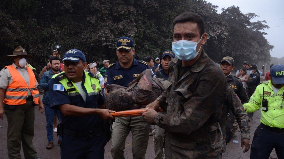 A group of workers from the rescue teams of Guatemala help a wounded person in El Rodeo, Escuintla, Guatemala, 03 June 2018.