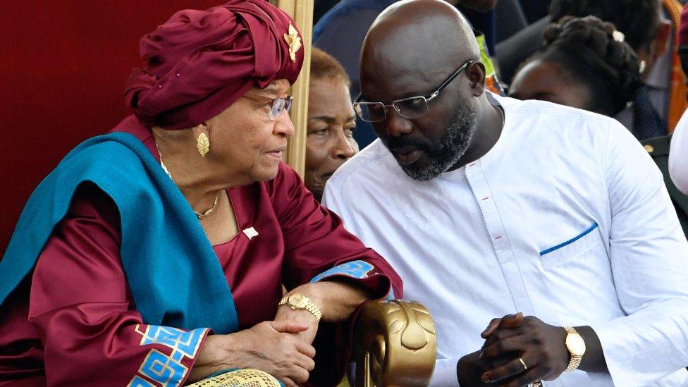 Liberia's outgoing president Ellen Johnson Sirleaf (L) listens to Liberia's President-elect George Weah, during Weah's swearing-in ceremony on January 22, 2018