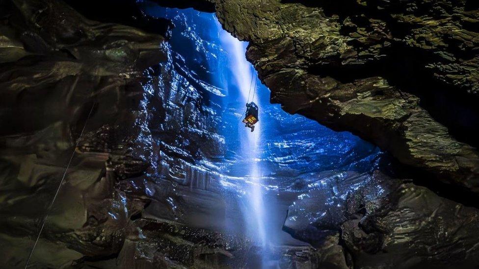 A potholer is winched into Gaping Gill