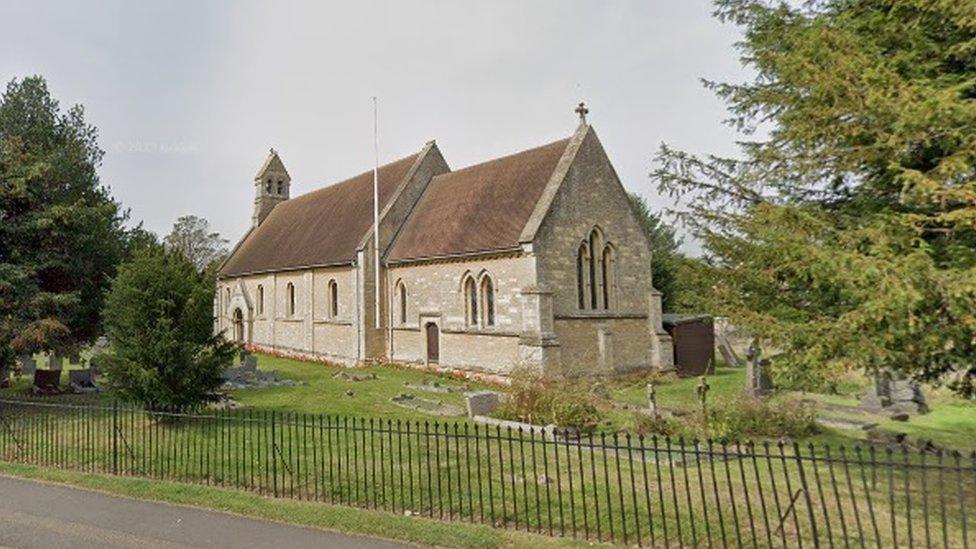 Scene showing small stone-built church and trees