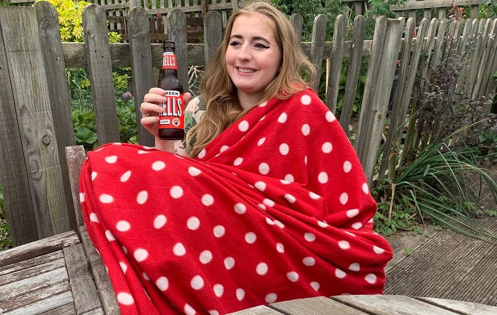 Eliza enjoys a beer in her garden