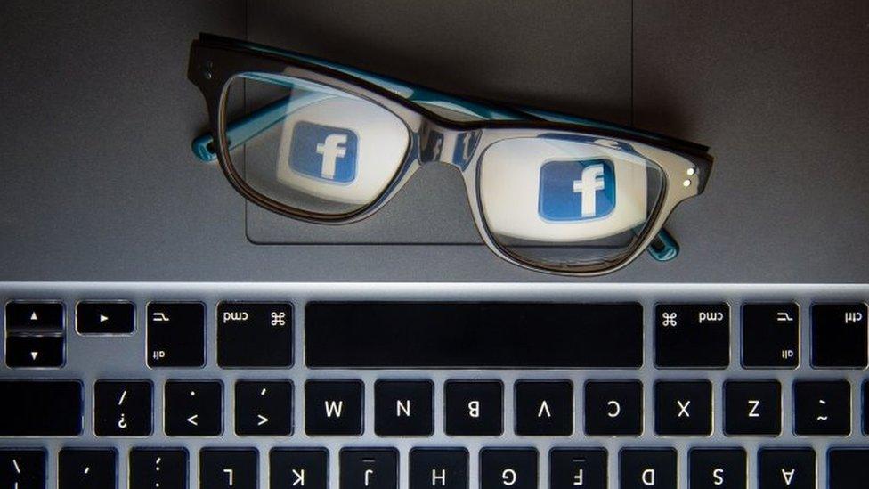 A photo showing Facebook's logo reflected in a pair of glasses.