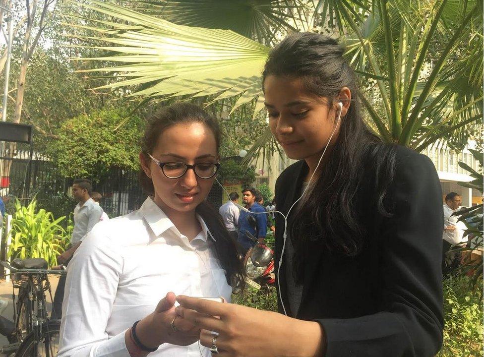 Raymon Singh, left, and Aparimita Pratap, watching Mr Trump's video