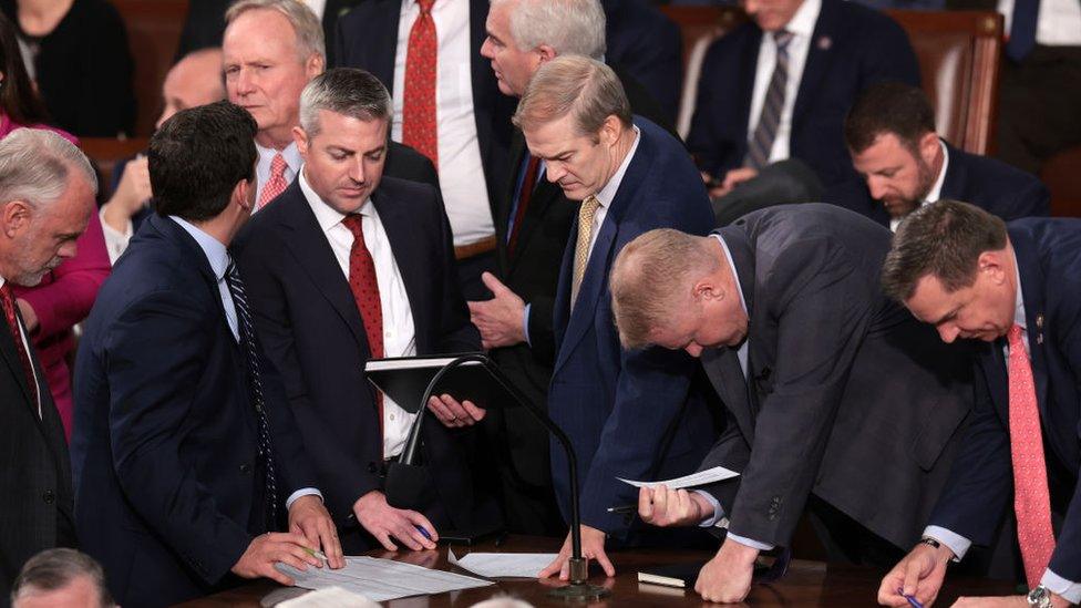 Jim Jordan talks with staff and fellow lawmakers as the House of Representatives meets to elect a new Speaker of the House