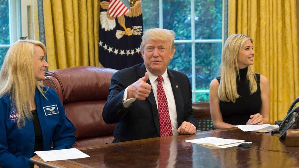 Donald Trump speaks along with his daughter Ivanka Trump (R) and NASA Astronaut Kate Rubins, during a video conference with NASA astronauts aboard the International Space Station in the Oval Office at the White House April 24, 2017 in Washington, DC