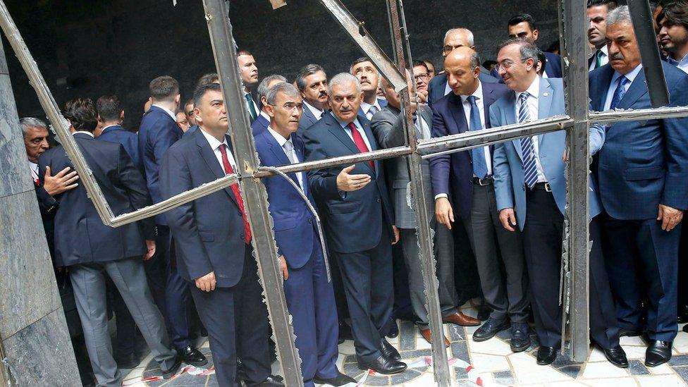 Turkey's Prime Minister Binali Yildirim (C) visits damaged parts of the Turkish parliament in Ankara, Turkey on Tuesday