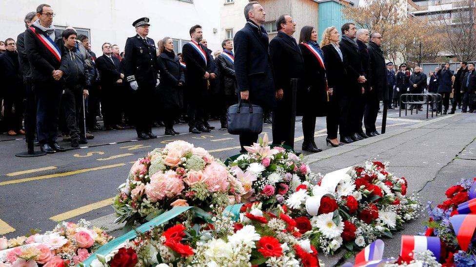 Former French President François Hollande, Paris mayor Anne Hidalgo and Justice Minister Nicole Belloubet pay their respects outside the former offices of Charlie Hebdo in Paris, 7 January 2020