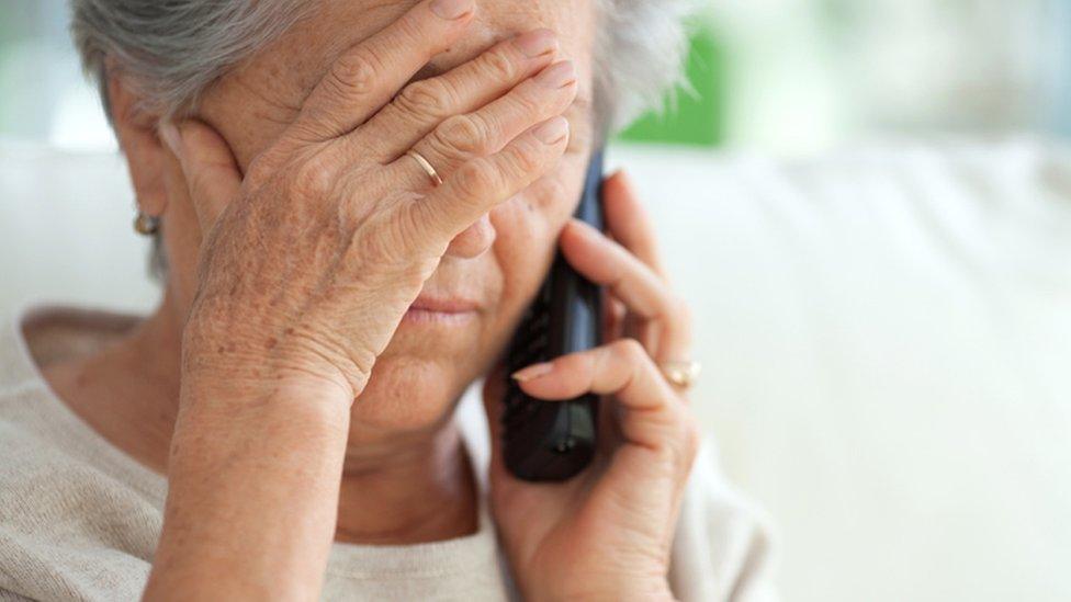 older, distressed woman on the phone