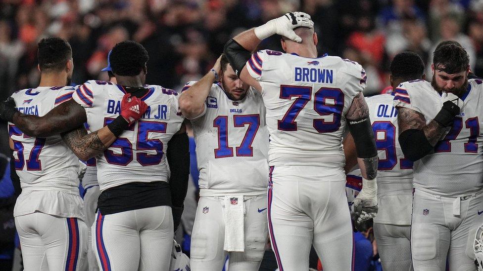 The Buffalo Bills gather as an ambulance parks on the field while CPR is administered to Buffalo Bills safety Damar Hamlin (3) after a play in the first quarter of the NFL Week 17 game between the Cincinnati Bengals and the Buffalo Bills at Paycor Stadium in Downtown Cincinnati. The game was suspended with suspended in the first quarter after Buffalo Bills safety Damar Hamlin (3) was taken away in an ambulance following a play. Mandatory Credit: Sam Greene-USA TODAY Sports