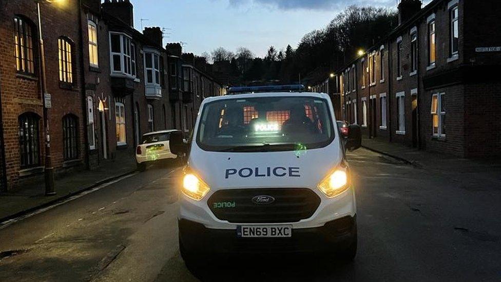 A police vehicle in a street during sunrise