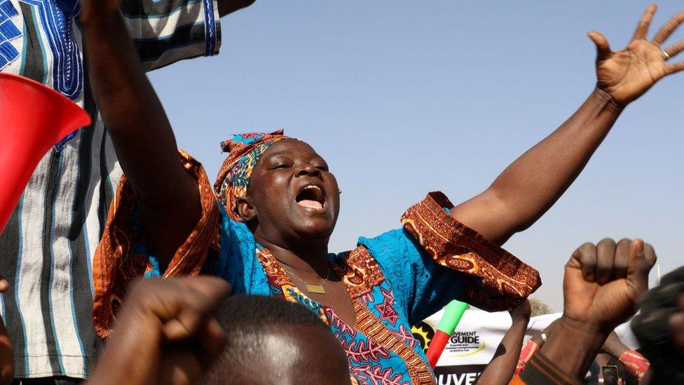 A woman reacts as people gather in support of a coup that ousted President Roch Kabore, dissolved government, suspended the constitution and closed borders in Burkina Faso, Ouagadougou January 25, 2022.