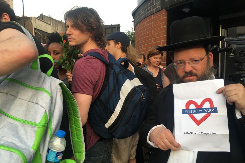 Man hold "we stand together" poster