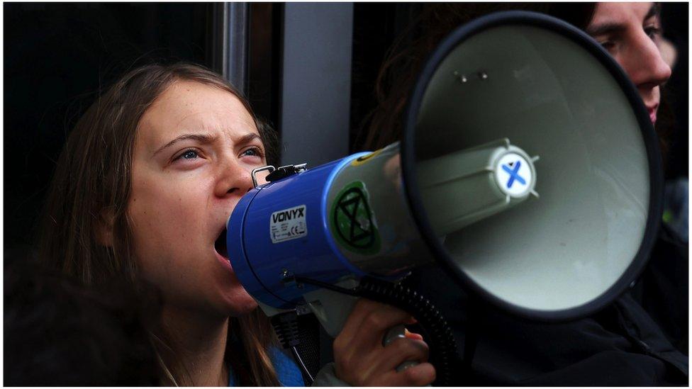 Greta Thunberg talking into loudhailer