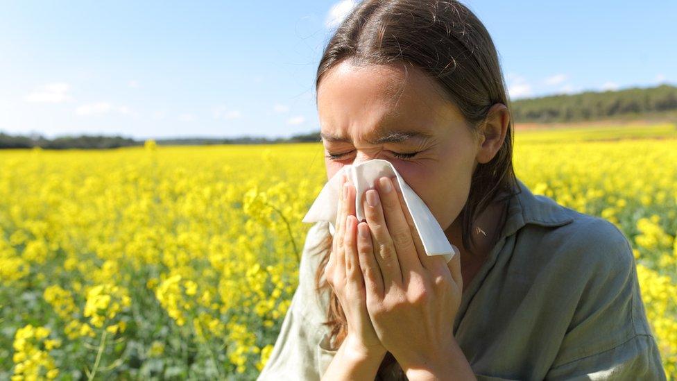 Woman sneezing