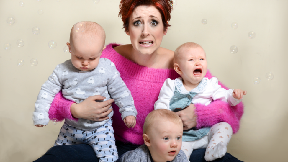 Connie Fisher holding babies