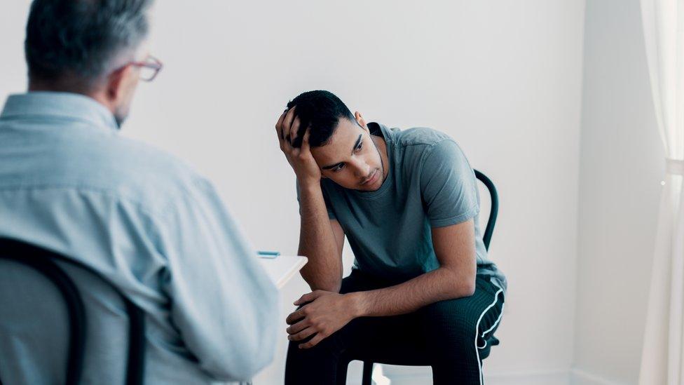 Man talking to therapist